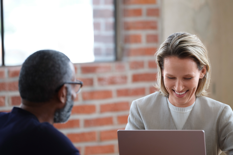 Two people talking smiling. 