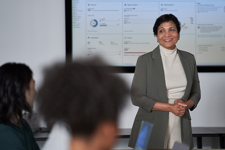 A person standing and presenting information to a group