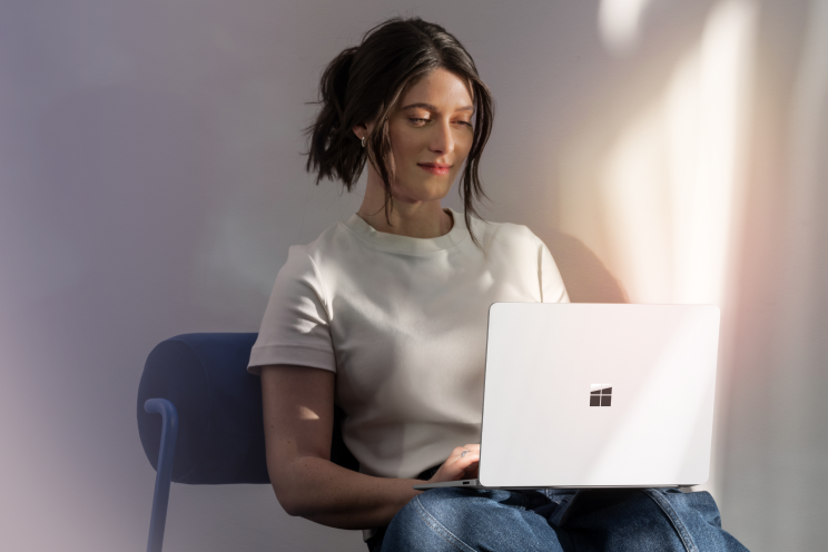 A person seated working on a laptop.
