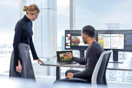 Two people looking at a tablet.