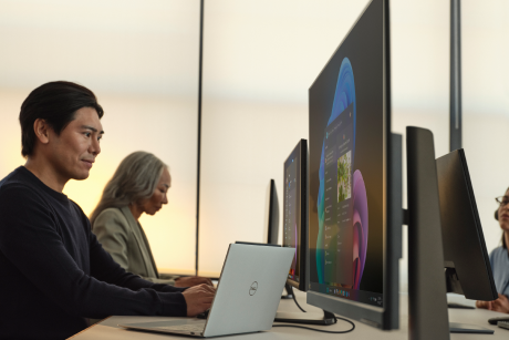 People working in front of large monitors.