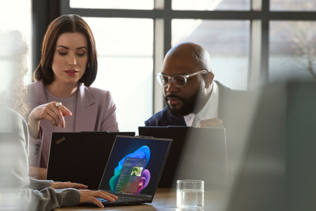 People sitting at a table working on laptops.