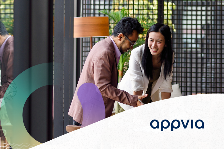 Two people collaborating and smiling.