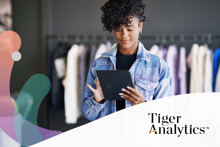 Person in a clothing retail store working on a tablet.