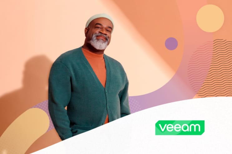 Smiling person in a sweater and hat Veeam logo is overlaid