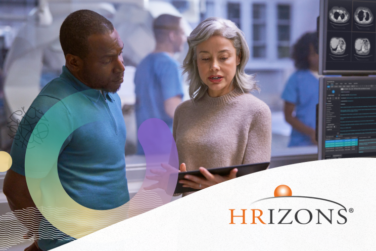 Two people working on a tablet.