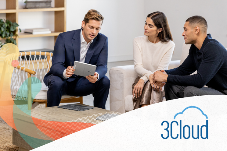 Three people seated on couches looking at a tablet