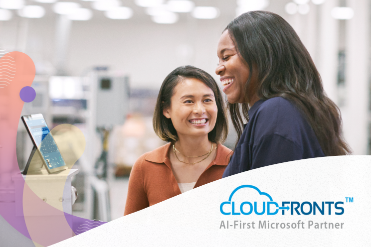 Two people laughing in an office.