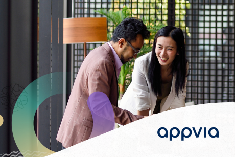 Two people collaborating and smiling.