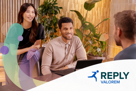 Three people talking at a conference table.