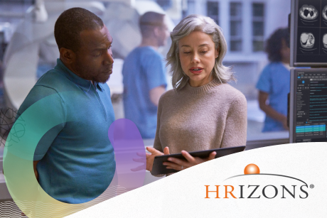 Two people working on a tablet.