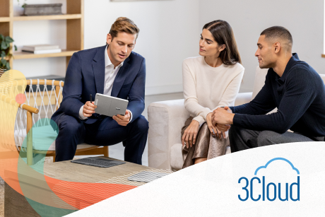 Three people seated on couches looking at a tablet