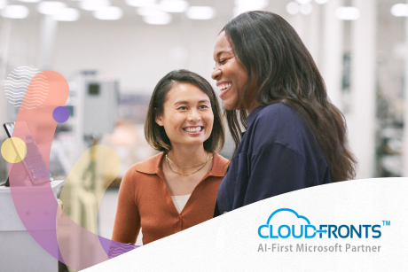 Two people laughing in an office.