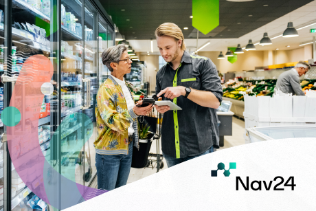 Two people in a grocery store looking at a mobile phone