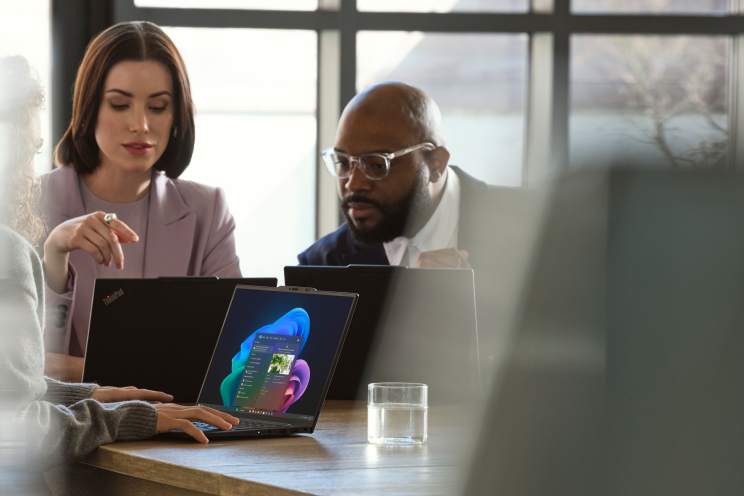 People sitting at a table working on laptops.