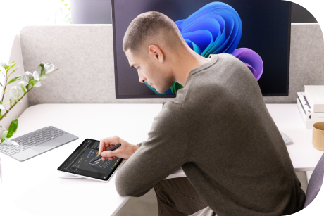 A person using a tablet and stylus.