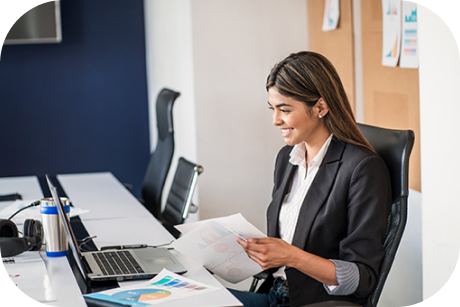 A person sitting and smiling at their laptop