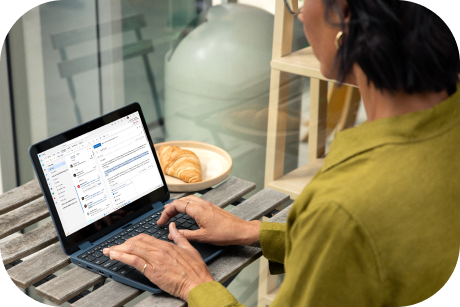 A person working on a laptop in a cafe.