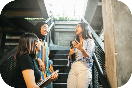 Three people talking on an outdoor staircase