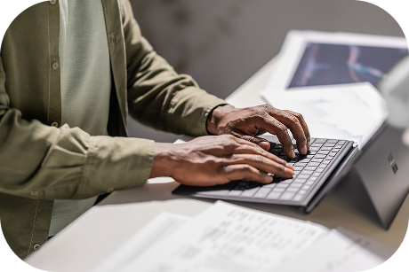 Person seated at a desk using a tablet