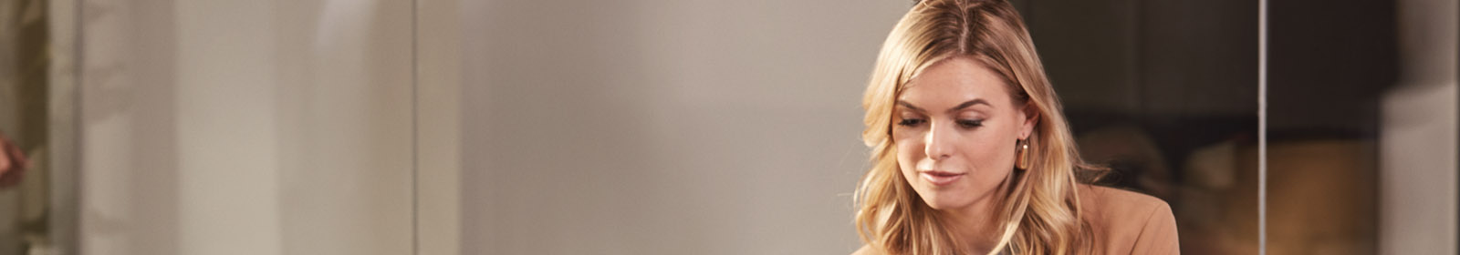 A smiling woman working on a laptop