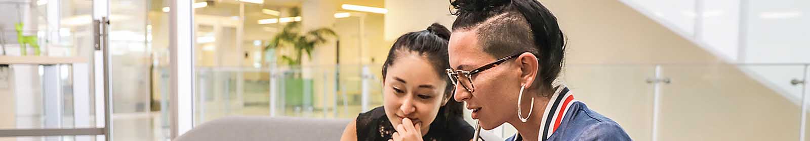 Two female colleagues collaborating with a laptop