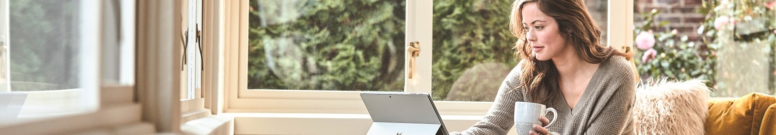 A woman works on a laptop at home