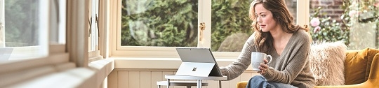 A woman works on a laptop at home