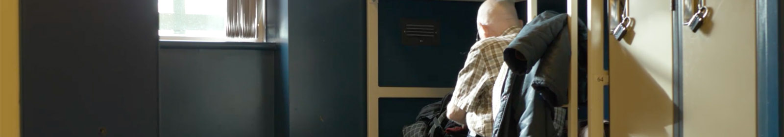 Man sitting in homeless shelter