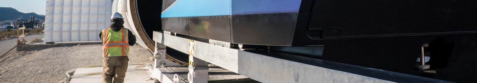 A worker passes by a Virgin Hyperloop One pod