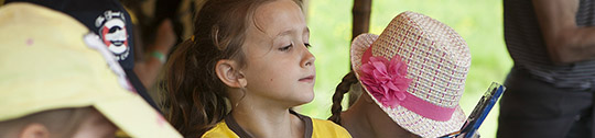 A young girl mixes paint during a Girlguiding activity