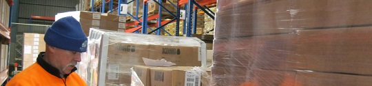 A KONG employee works in a warehouse