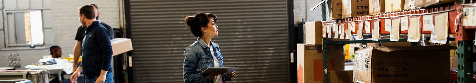 A warehouse operations manager checks inventory