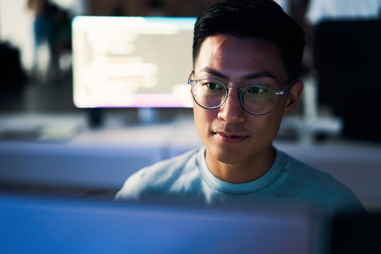 Person wearing glasses looking at a computer screen