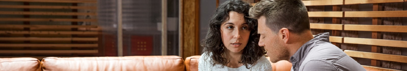 Colleagues discuss a project in a casual office setting