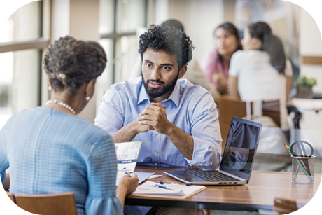 Two people sitting at a table and talking