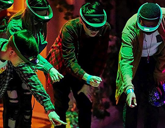 A group experiences an augmented reality exhibit 