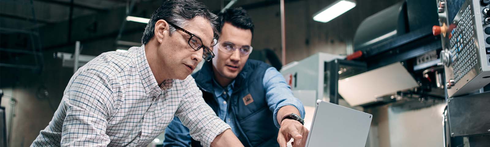 Two men in shop looking at a computer screen