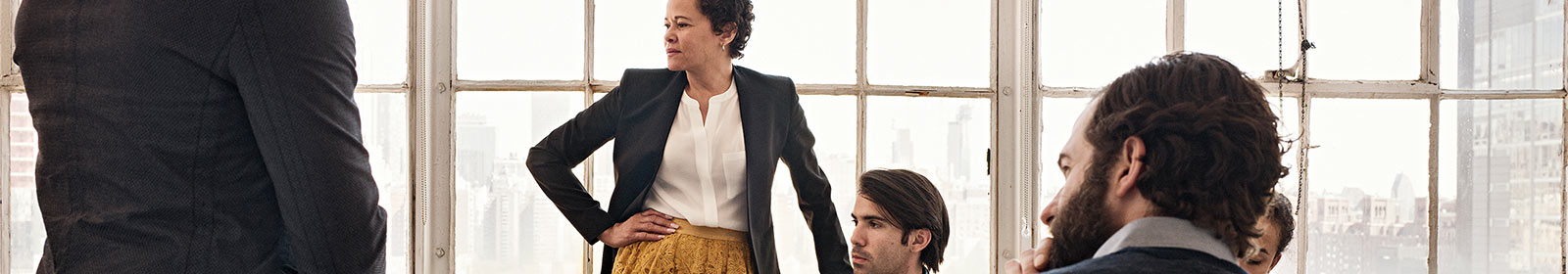 Coworkers sitting in conference room looking at presentation