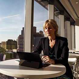 Woman sitting at table working on Surface
