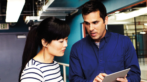 Man and woman looking at a tablet