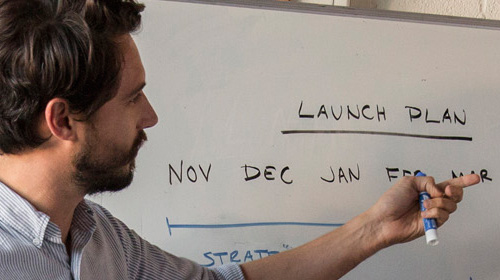 Man gesturing to whiteboard