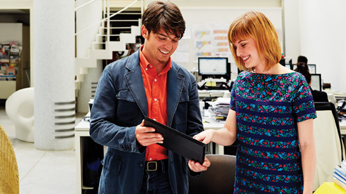 Smiling couple looking at a tablet
