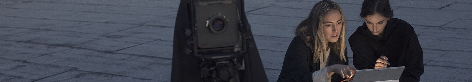 Two women set up a camera