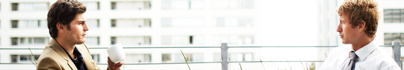 Two men engaging over coffee