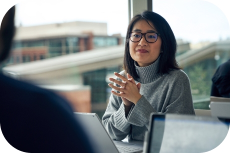 A person sitting at a table with a laptop