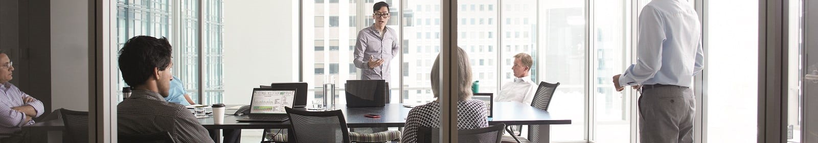 Workers listen at a meeting