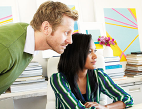 Two people looking at a computer