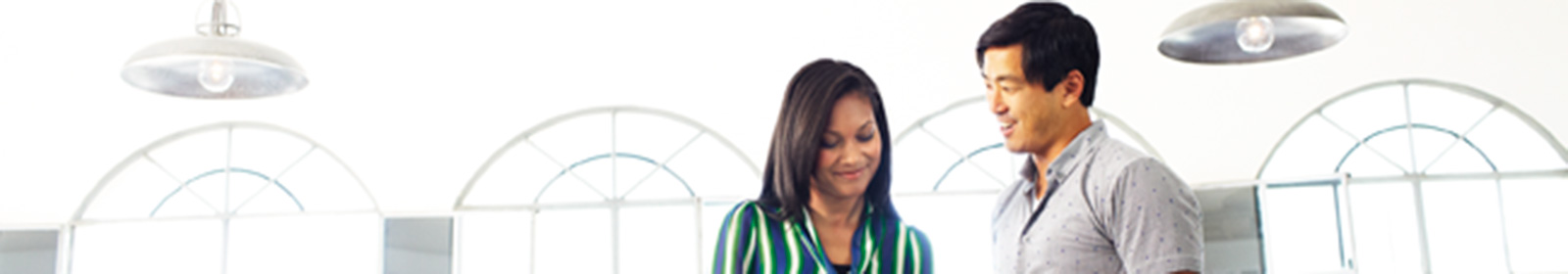 two people talking with windows behind