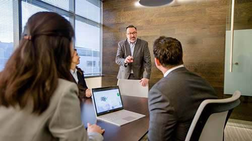 Coworkers talking in conference room